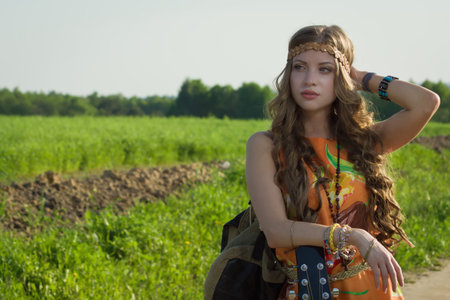Amazing girl travelling with her guitar. Hippie style.の写真素材