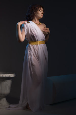 Beautiful Woman Wearing White Greek Toga on a dark backgroundの写真素材