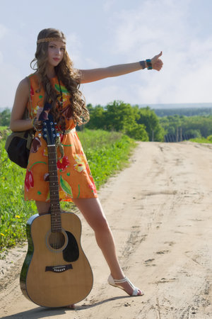 Romantic girl travelling with her guitar. Hippie style.の写真素材
