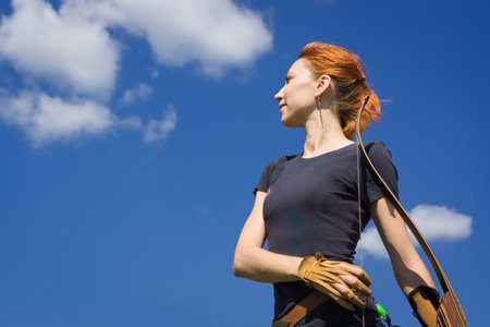 Archery woman with a bow in the summer fieldの写真素材