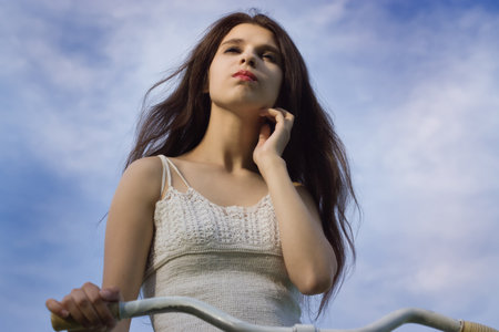 Portrait of pretty girl with bicycle in retro styleの写真素材
