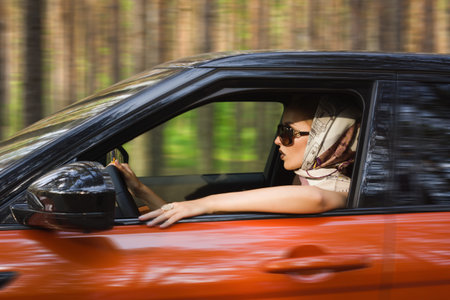 Fashion vintage woman behind steering wheel
