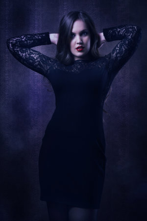 Pretty woman in a black dress in the boudoirの写真素材