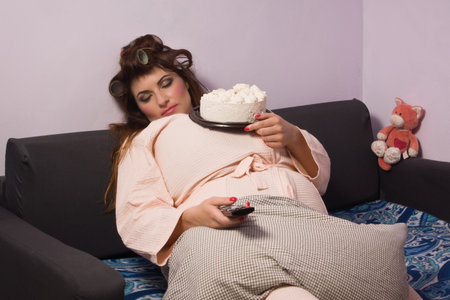 Overweight Woman Relaxing On Sofaの写真素材