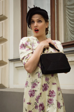 Very beautiful soviet girl in retro style is on the Moscow streetの写真素材