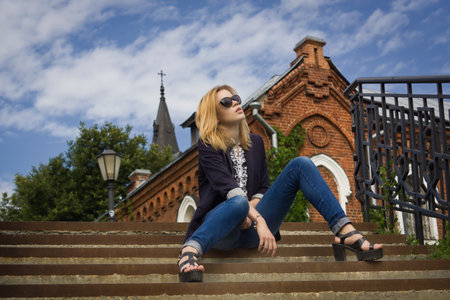 Beautiful fashion woman wearing sunglasses  walking on the european streetの写真素材