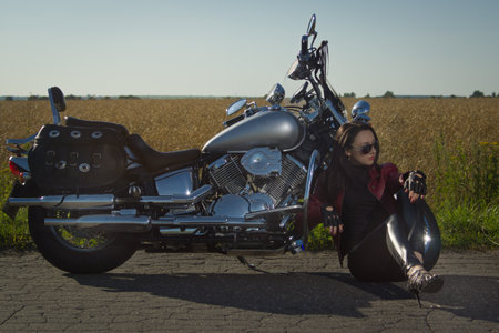 Sexy biker girl in a leather jacket on a motorcycleの写真素材