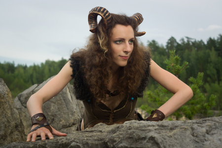 Pretty female faun in a wood. Mythological creature in a forestの写真素材