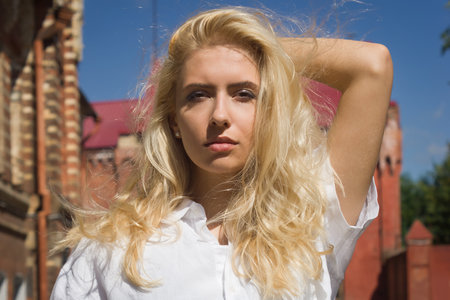 Fashion outdoor photo of beautiful woman wearing elegant clothes and posing in city streetの写真素材