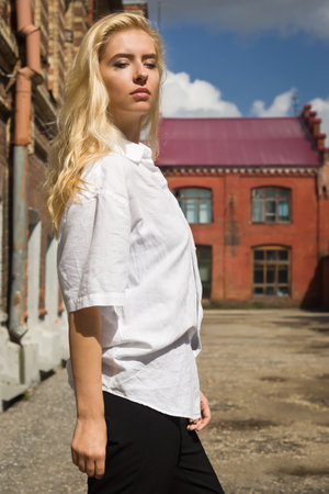 Fashion outdoor photo of beautiful woman wearing elegant clothes and posing in city streetの写真素材