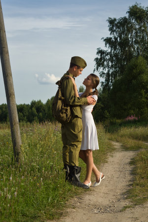 Soviet soldier in uniform of World War II saying goodbye to girlの写真素材