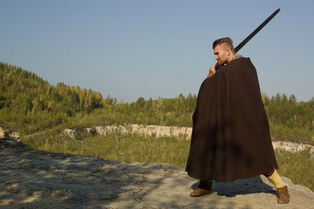 Viking attacking with a sword in the mountainsの写真素材