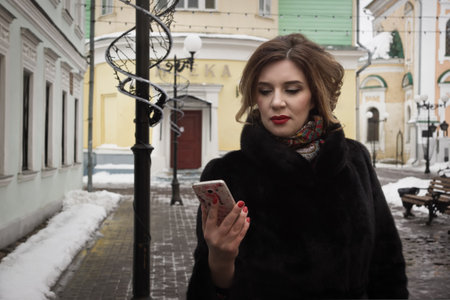 A woman in a fur coat on a city street. Unsuccessful rendezvous. He did not come.の写真素材