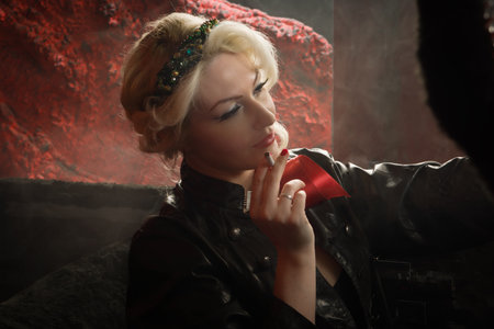 Pin Up Girl in a Classic Car on the road at duskの写真素材