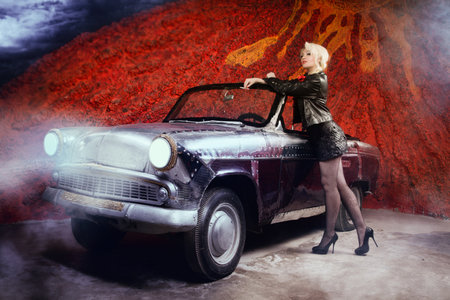 Beautiful sexy blonde pin up style girl posing with  retro carの写真素材