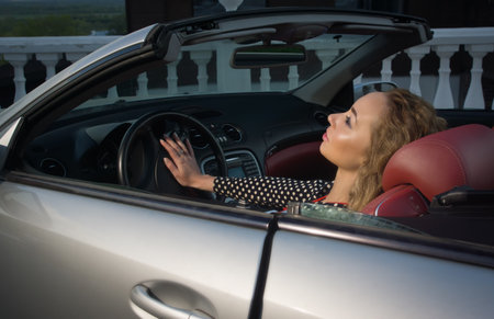 Attractive sensual fashionable woman in a car