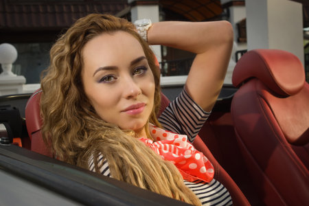 Attractive sensual fashionable woman in a car