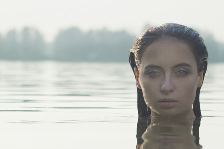 Beautiful mermaid on the summer forest lakeの写真素材