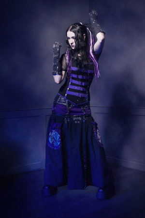 Cyber gothic girl in a dark room interior