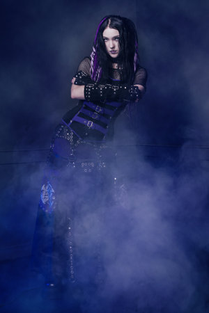 Cyber gothic girl in a dark room interiorの写真素材