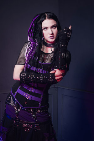 Cyber gothic girl in a dark room interior