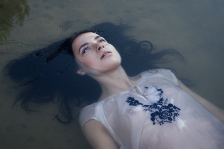 Young drown woman in a poetic representation.の写真素材