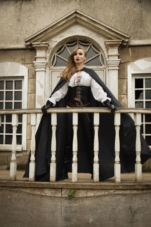 Fashion portrait of sexy woman in pirate style with old handgunの写真素材