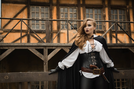 Fashion portrait of sexy woman in pirate style with old handgunの写真素材