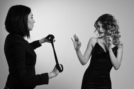 Film noir. Hitwoman strangled the beautiful young woman with black scarfの写真素材