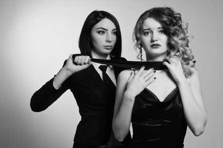 Film noir. Hitwoman strangled the beautiful young woman with black scarfの写真素材