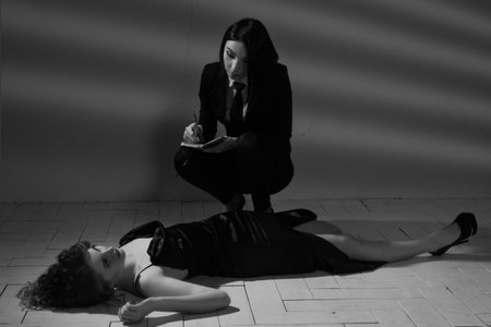 Film noir. Detective woman investigating the crime sceneの写真素材