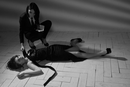 Film noir. Detective woman investigating the crime sceneの写真素材