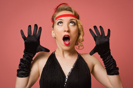 Gorgeous vintage 1920s lady in a black dress with headbandの写真素材