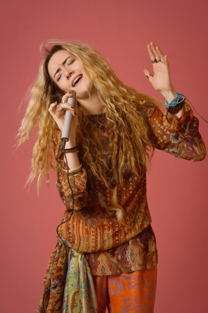 Rock star singing into a microphone. Hippie girl.の写真素材