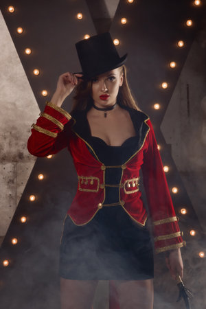Beautiful woman trainer in a circus suit and a hat.の写真素材