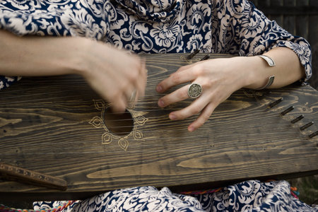 Gusli folk musical instrument in woman hands. Motion blurの写真素材