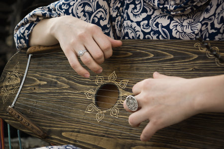 Gusli folk musical instrument in woman hands. Motion blurの写真素材