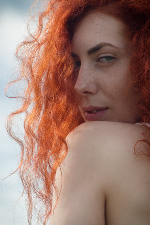 Close up portrait of a beautiful girl with long red hair