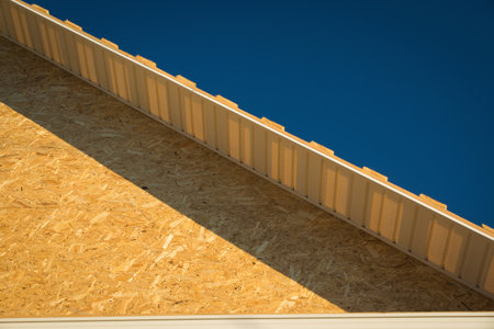 Construction of the roof of the house. Metal tiles