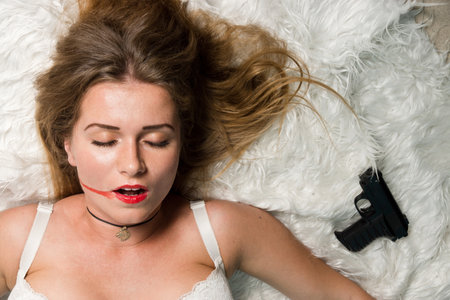 Crime scene simulation: lifeless woman lying on the floorの写真素材