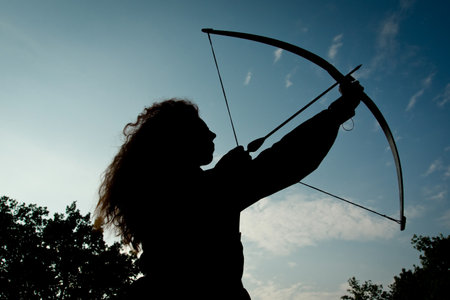 Red haired girl shoots from the bow. Fantasy concept