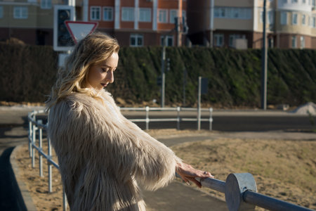 Fashionable girl walking on a city landscapeの写真素材