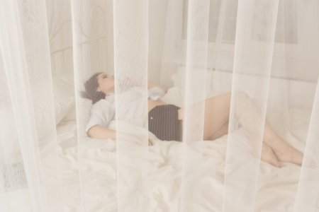 Young pretty girl sleeping in a boudoirの写真素材