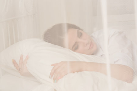 Young pretty girl sleeping in a boudoirの写真素材