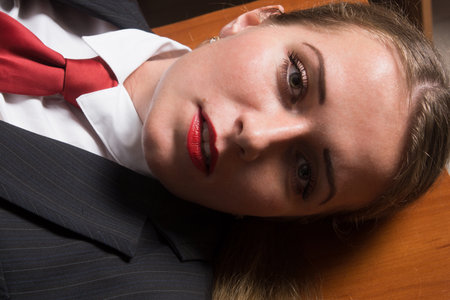 Crime scene with strangled pretty business woman in officeの写真素材