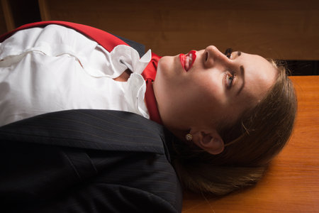 Crime scene with strangled pretty business woman in office