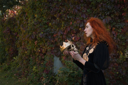 Medieval Queen with a sword in one hand and a skull in the otherの写真素材