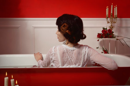 Beautiful sexy woman in vintage bathroom with flowers petals. Spa body care.の写真素材