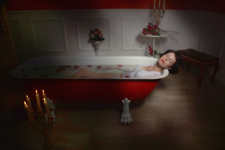 Beautiful sexy woman in vintage bathroom with flowers petals. Spa body care.