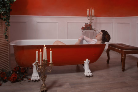 Beautiful sexy woman in vintage bathroom with flowers petals. Spa body care.
の写真素材